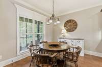 There is an eat-in area in the kitchen that overlooks the backyard and opens to the screened back porch.