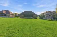The whole yard irrigation system keeps this yard looking lush. The large screened porch will be your favorite spot to spend time in the private view.