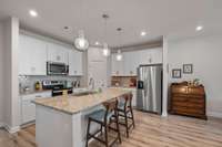 Kitchen with a walk in pantry, a large island, and opens to the living and dining area