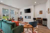 Living Room is bright and spacious with an electric fireplace flanked by alcoves