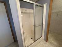 Walk-in shower with handy seat.