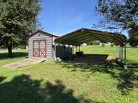 Utility building with ramp and large carport.