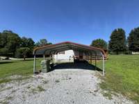 One of two covered carports that go with the home. Walk directly from you vehicle under the carport to the covered porch straight into the kitchen!