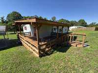This covered porch wraps around the side and back of the home with direct access to the back yard.