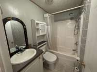 Full Bath located in the hall between second and third bedrooms.