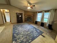 Great room area with fireplace and view of the backyard.