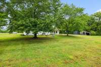 Mature trees in front and rear yard provide optimum shade.