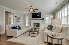 So many ways to configure this living room with oversized furniture, focused around the painted brick fireplace