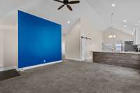 Recessed lighting throughout the home and nice open flow between living, kitchen, and dining areas. Barn door leads to laundry room. 