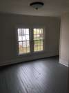 Upstairs bedroom , plank flooring, sheet rock walls 