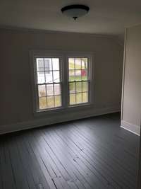 Upstairs bedroom , plank flooring, sheet rock walls 