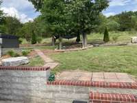 Walkway leads to the hot tub, grilling and fire pit area.