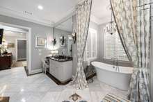 No detail missed in this amazing Master Bath with Carrera Marble floors and elegant lighting.