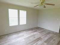 The primary bedroom light filled with good Window views, and new flooring