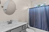 Additional full bathroom with tub/shower combo located conveniently between the two guest bedrooms 