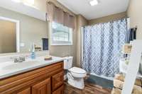 Main bathroom in the hallway that also has the upgraded cabinetry.