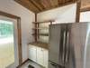 Open shelves with work stain, new side by side refrigerator.