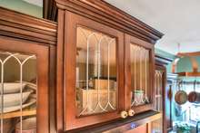 Kitchen cabinets have several custom order leaded glass doors.