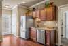 Rinse those dishes even in the dark by switching on the under cabinet lights! Fridge and dishwasher to stay! Tons of cabinet space for all of those clean dishes. 