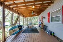 Look at this wonderful large porch across the front of this great lake front home! 