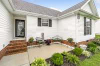 Beautiful front patio area welcomes guests and is a wonderful outdoor living space.