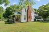 Here you can see the screened in sunporch and beautiful chimney. The driveway is on this side of the home.