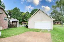 Oversize detached garage, the original house garage was converted into a den by previous owners. 