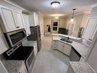 Kitchen with plenty of cabinet space and refrigerator remains!