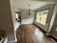 Dining room located just off the living room with view of backyard through large double window.