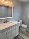 Bathroom also has soft-close doors and drawers, and tiled tub/shower combination, and linen closet.