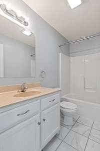 Second full bath features new tile flooring and neutral colored pained walls. 