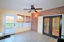 Florida Room off the kitchen looks out to the pool area. 