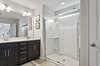 Double vanity and large walk in shower with upgraded shower door. 