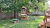 Fully fenced back yard with shade trees