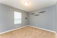 This is Bedroom #3, located on the upper level of this home and has carpeted flooring.