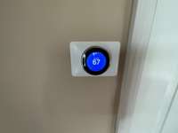 Nest thermostat downstairs. Owner has purchased one for the upstairs which will remain with the house but has not been installed yet.