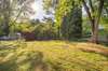 Beautiful fenced in backyard with storage building