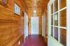 Entrance to the Shop currently used as a professional dog kennel (White Oak Kennel) Beautiful bead board in the shop ceiling also., To the right there is plumbing. Storage to the left. The shop is 30x40 and has 12 Ft Overhangs off of both sides.