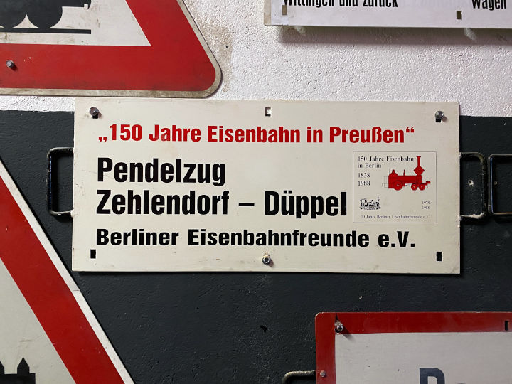 Werbeschild 150 Jahre Eisenbahn in Preußen, Pendelzug Zehlendorf – Düppel der Berliner Eisenbahnfreunde e. V.