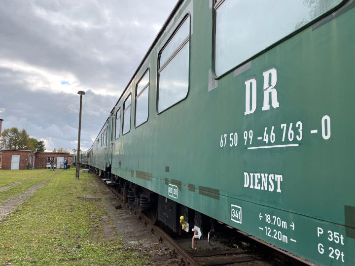 Grüner Eisenbahnwagen DR 67 50 99 – 46 763 – 0 auf dem Außengelände des Historischen Lokschuppens in Wittenberge