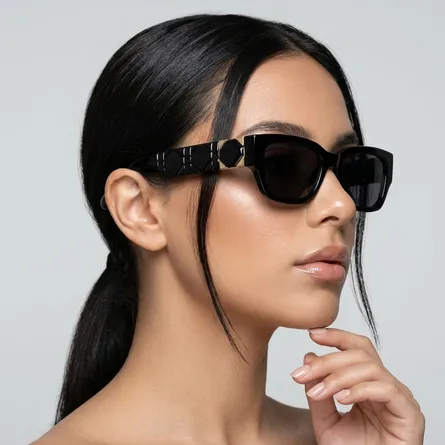 Woman-wearing-glossy-black-cat-eye-sunglasses-with-dark-tinted-lenses-and-sleek-narrow-frame-design