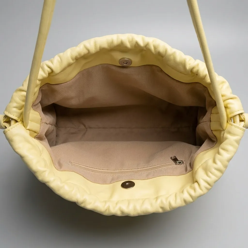 Pastel-yellow-faux-leather-ruched-shoulder-bag-with-drawstring-detail-spacious-lined-interior-and-inner-zip-pocket