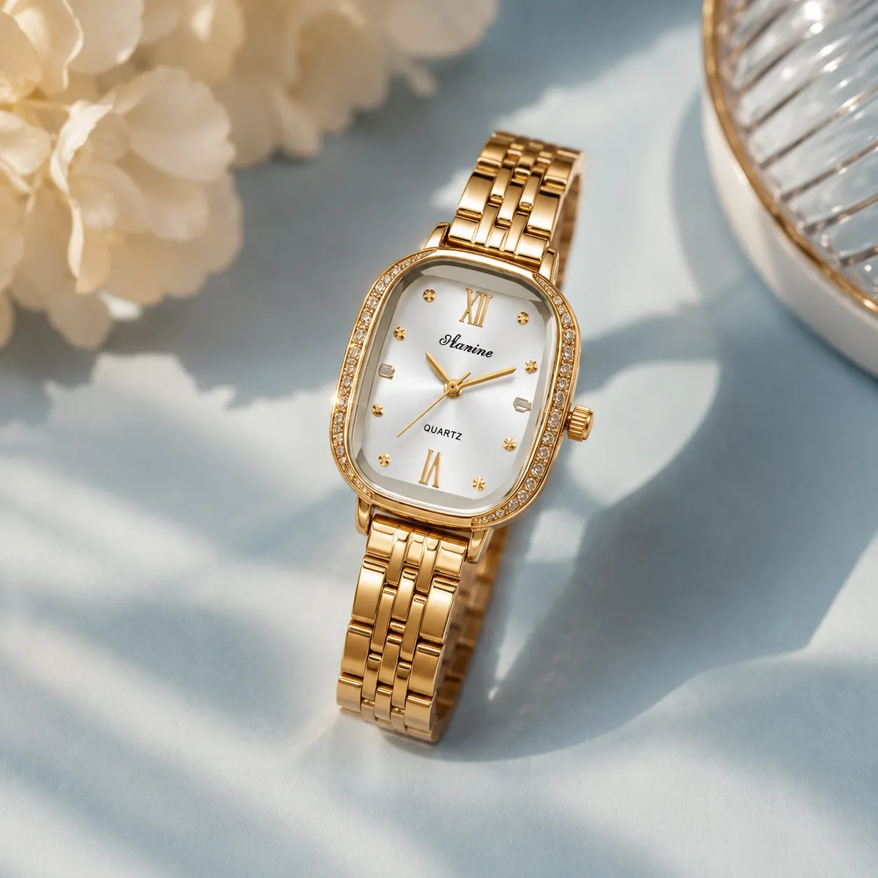 Gold-tone-rectangular-quartz-watch-with-crystal-studded-bezel-and-metal-strap-for-women