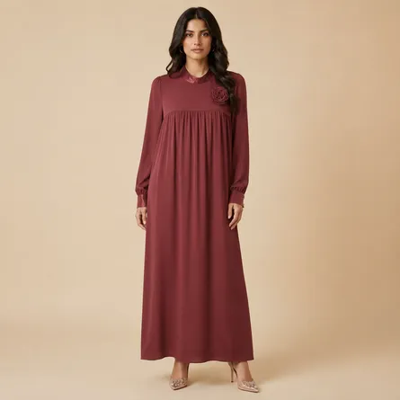 Maroon-maxi-dress-with-high-round-neckline-floral-rosette-detail-long-puff-sleeves-gathered-bodice-flowy-modest-fit