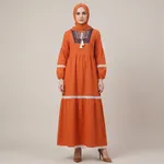 Orange-embroidered-tiered-maxi-dress-with-tassel-tie-neck-and-long-puff-sleeves
