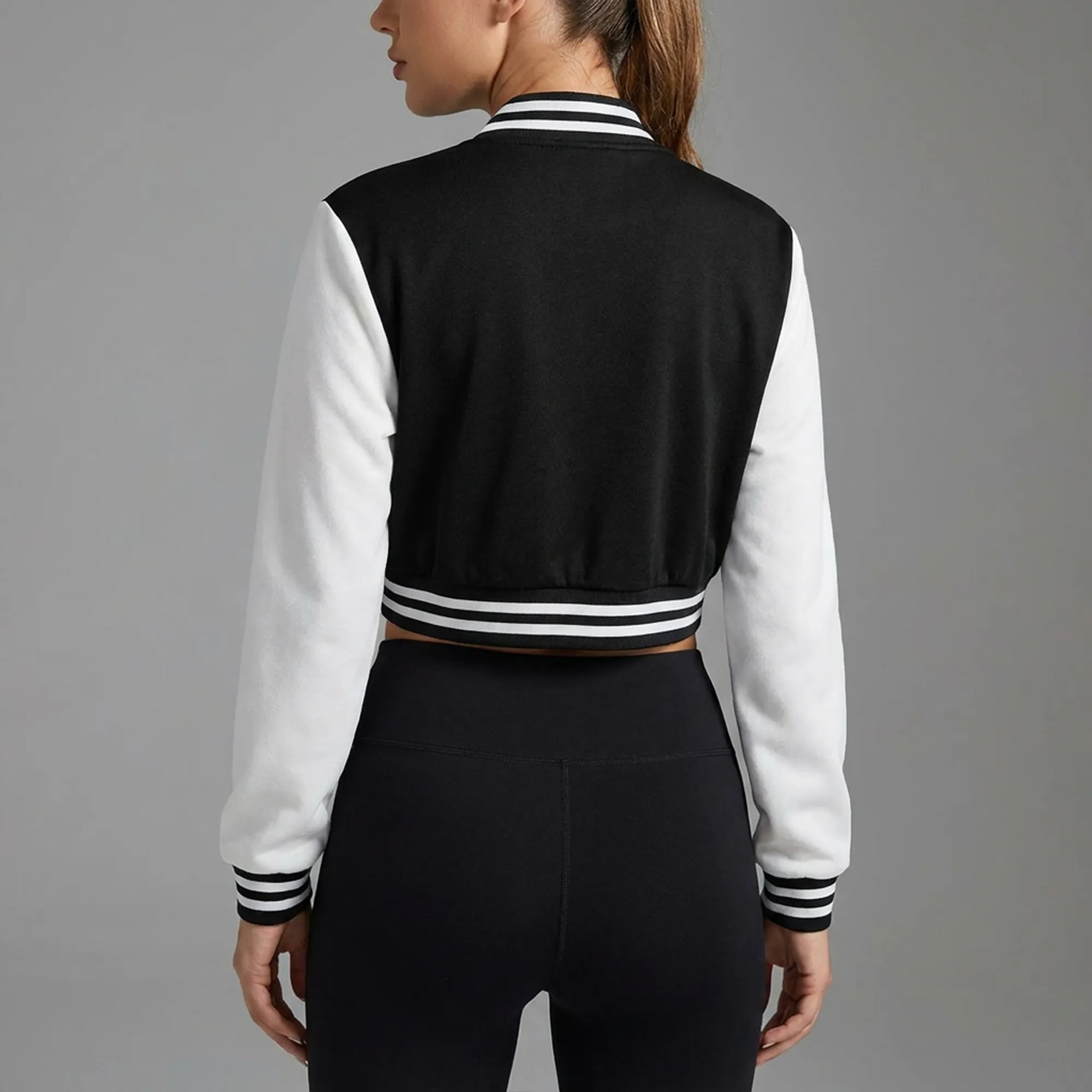 Black-and-white-cropped-varsity-jacket-for-women-with-contrast-sleeves-and-snap-button-closure