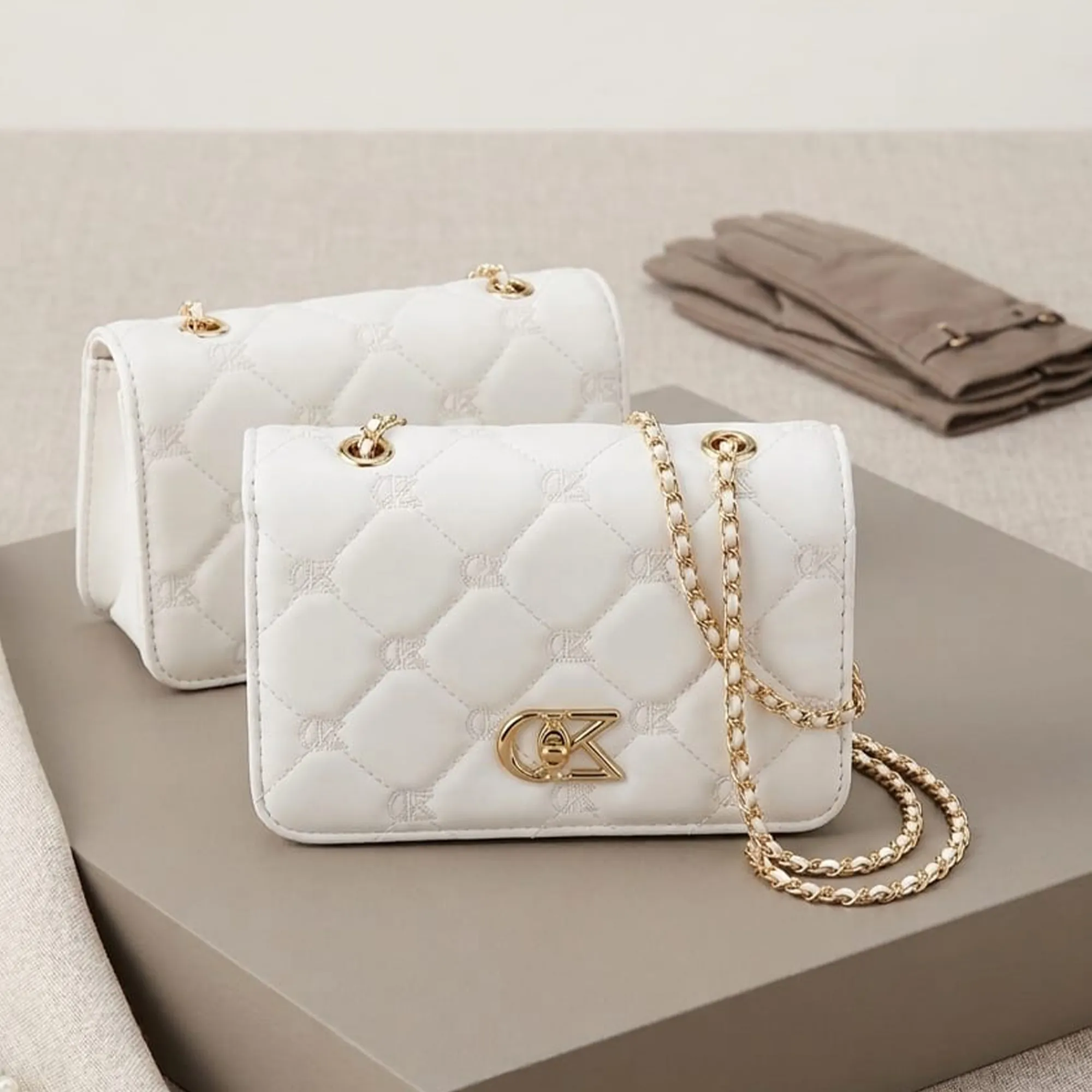 White-quilted-chain-sling-bag-with-gold-metal-detail-for-women