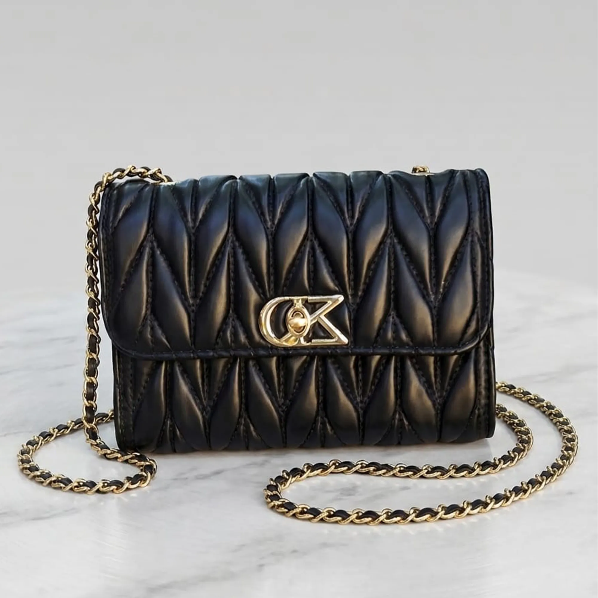 Black-quilted-chain-sling-bag-with-gold-metal-clasp-for-women