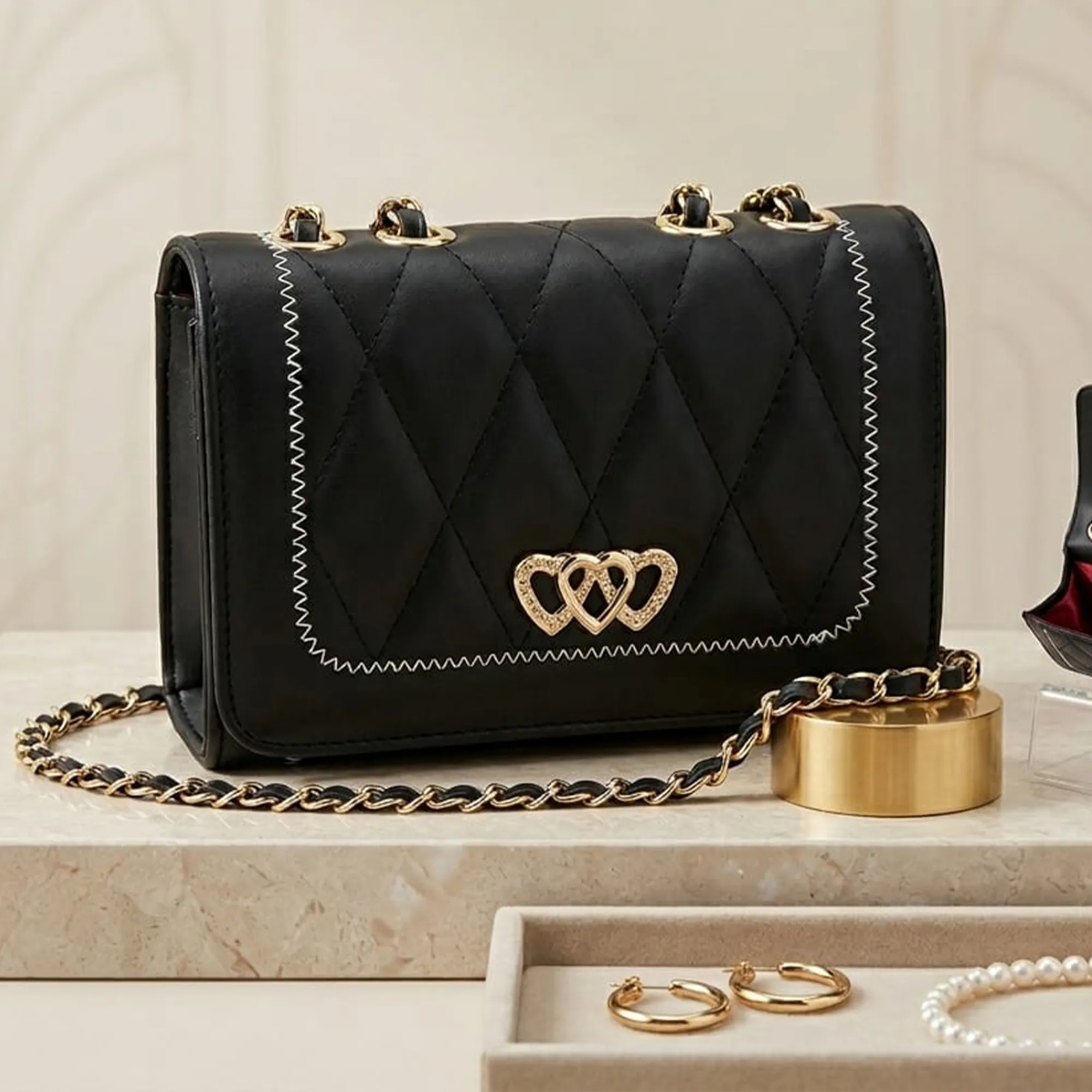 Black-quilted-chain-sling-bag-with-triple-heart-metal-lock-for-women