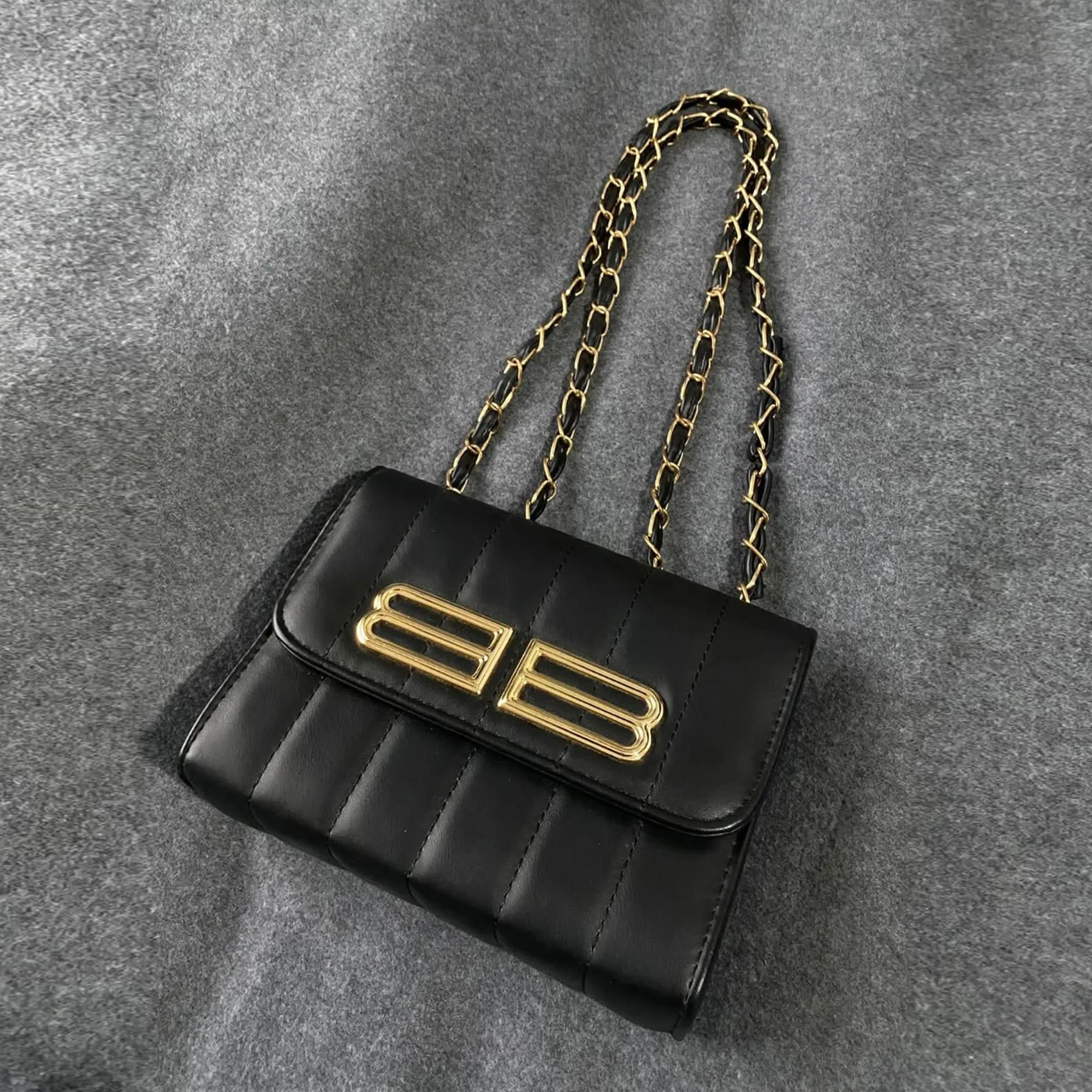 Black-quilted-faux-leather-chain-sling-bag-with-gold-clasp-for-women